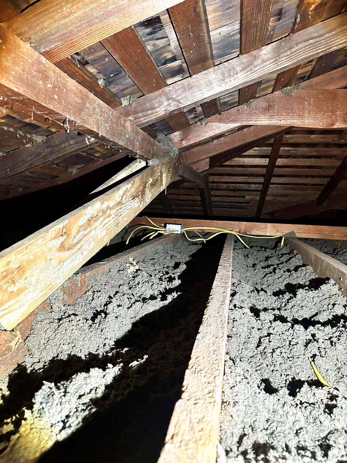 Old, uneven blown-in insulation — gaps and settling